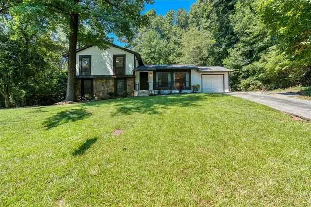 a front view of a house with a garden
