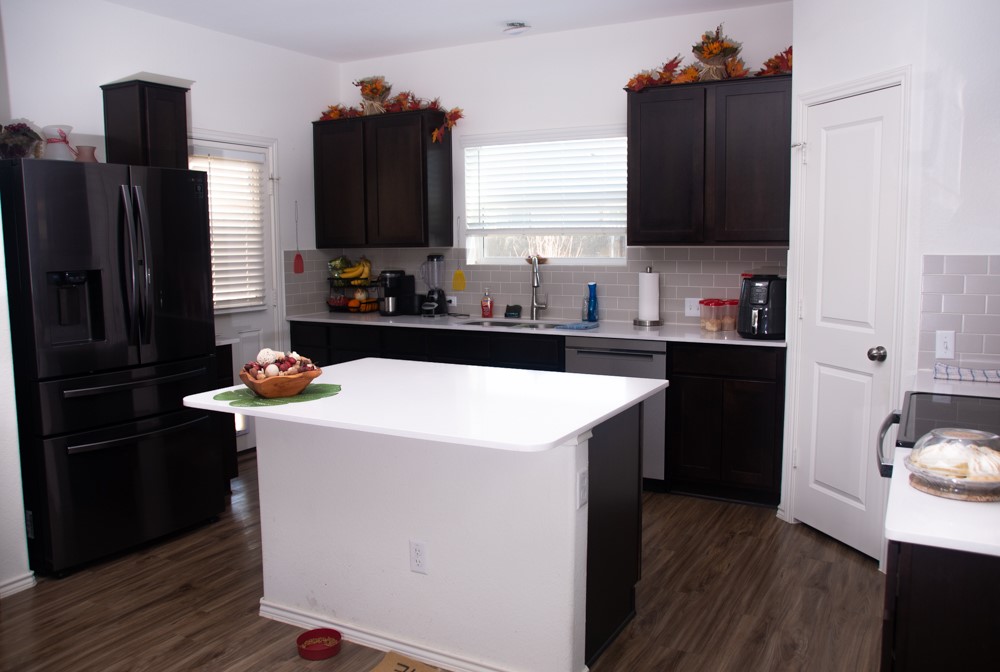 208 Greatest Gift Way Jarrell, TX 76537 - Photo 6 of 17 a kitchen with a sink refrigerator and microwave