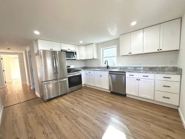 a kitchen with stainless steel appliances a refrigerator sink and cabinets