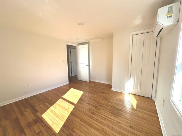 a view of wooden floor and windows in a room