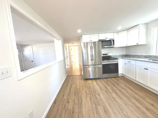 a kitchen with stainless steel appliances a refrigerator and a stove top oven