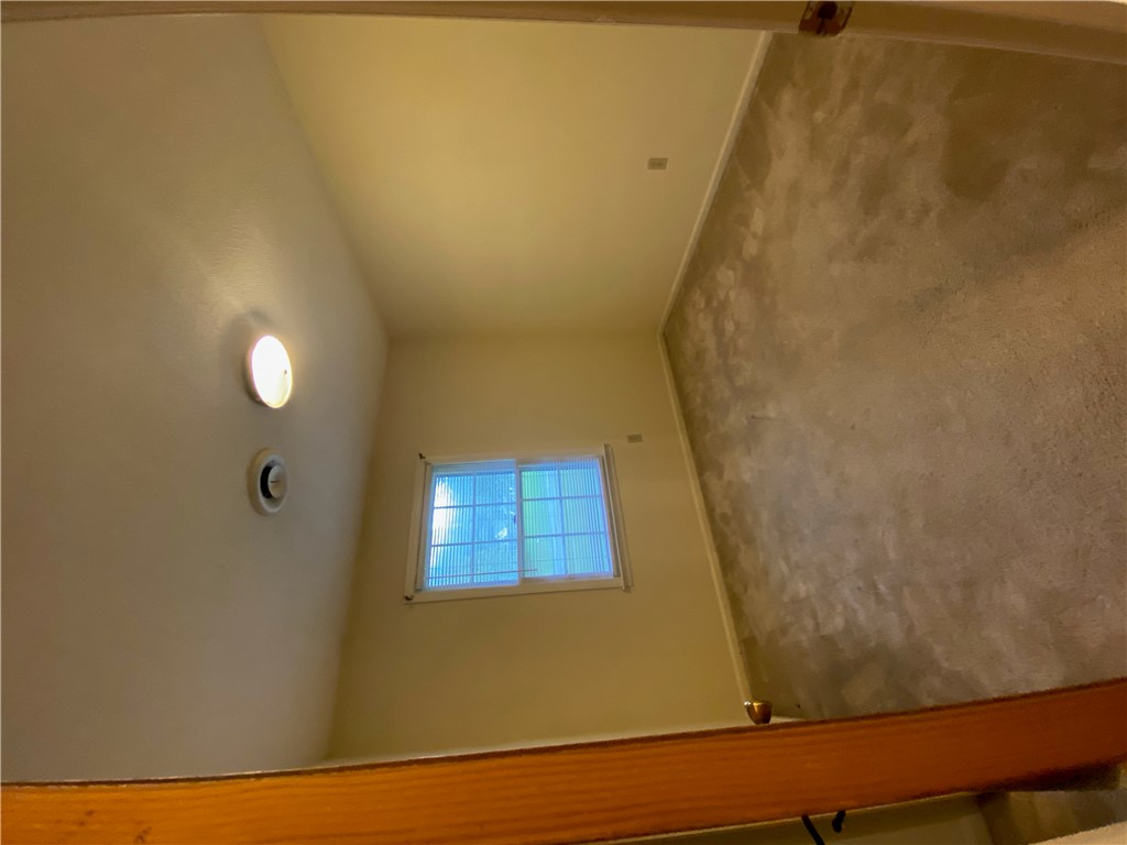 1424 East Calhoun Street Anderson, SC 29621 - Photo 5 of 10 An inviting upper-level space features a window with natural illumination and durable carpeted flooring.