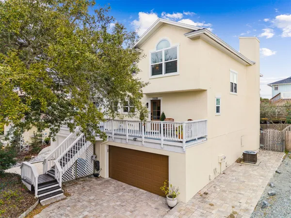 a view of a white house with large windows