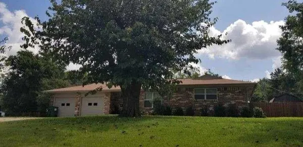 a view of house with backyard