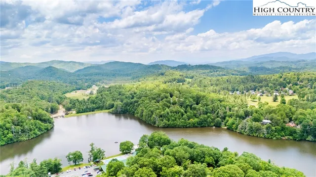 an aerial view of a house with garden space and lake view