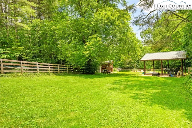 a patio with a table and chairs and a barbeque
