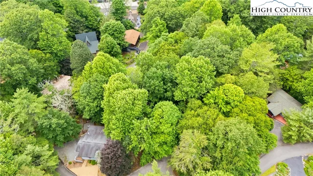 an aerial view of a house with yard