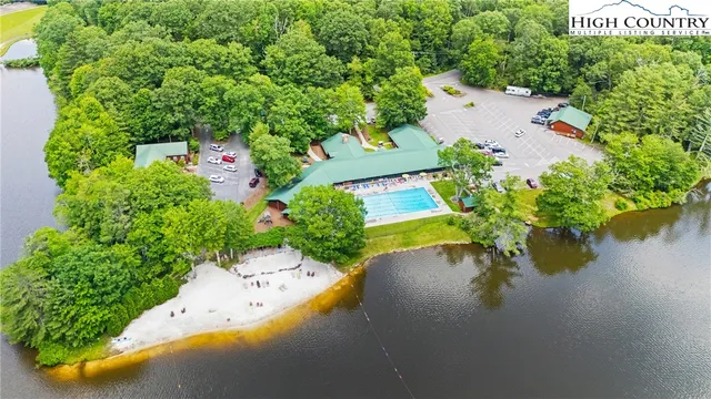 an aerial view of a house with yard swimming pool and outdoor seating