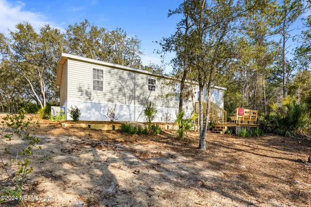a roof deck with wooden fence and trees