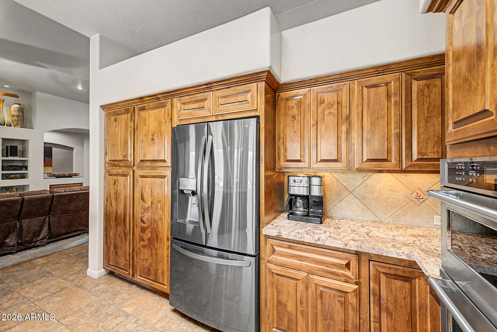 27909 North Quail Spring Road Rio Verde, AZ 85263 - Photo 14 of 52 a kitchen with granite countertop stainless steel appliances a refrigerator and cabinets