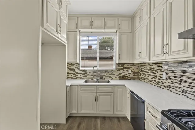 a kitchen with granite countertop white cabinets and a stove