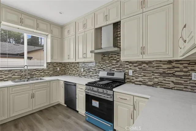 a kitchen with stainless steel appliances granite countertop a sink stove and cabinets