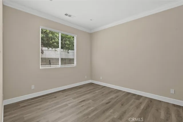 a view of a room with wooden floor and windows