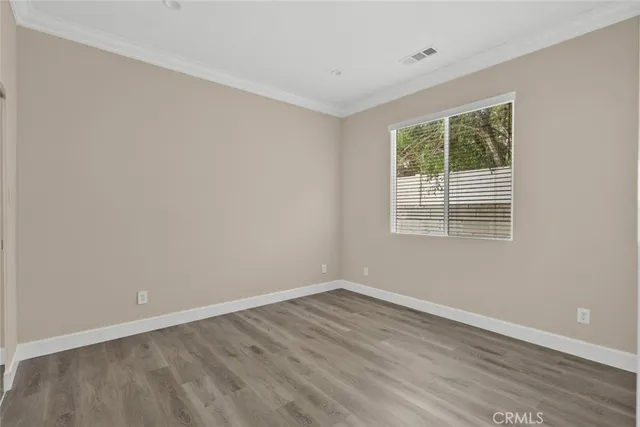 a view of a room with wooden floor and windows