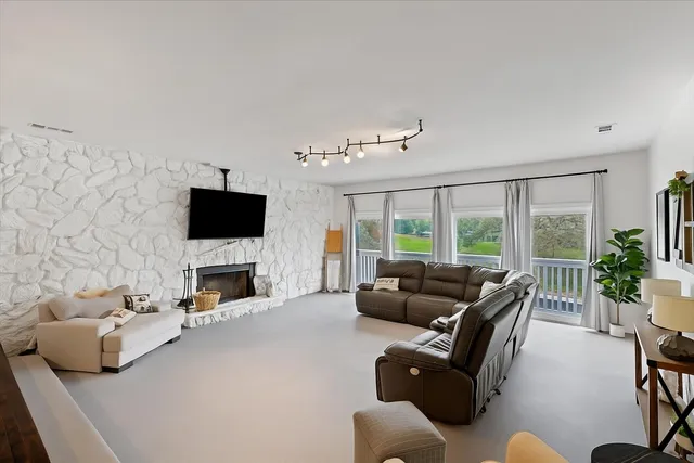a dining room with wooden floor a chandelier a wooden table and chairs