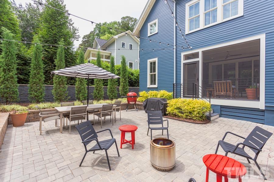 2709 North Mayview Road Raleigh, NC 27607 - Photo 59 of 66 a patio with a table and chairs under an umbrella