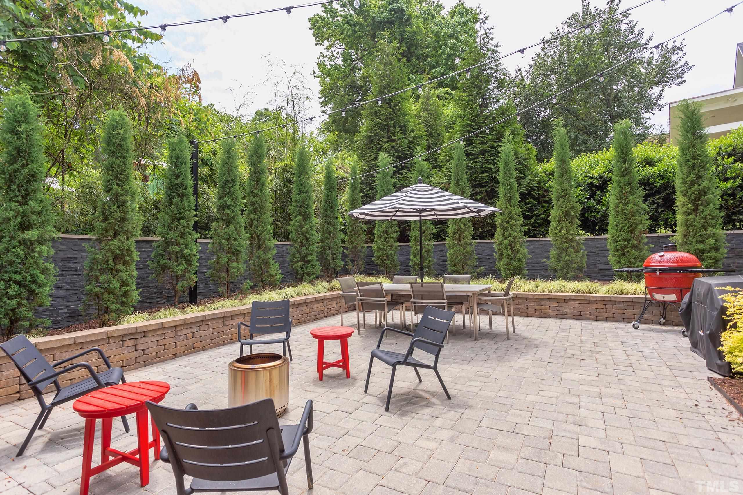 2709 North Mayview Road Raleigh, NC 27607 - Photo 60 of 66 a view of a patio with a table and chairs under an umbrella