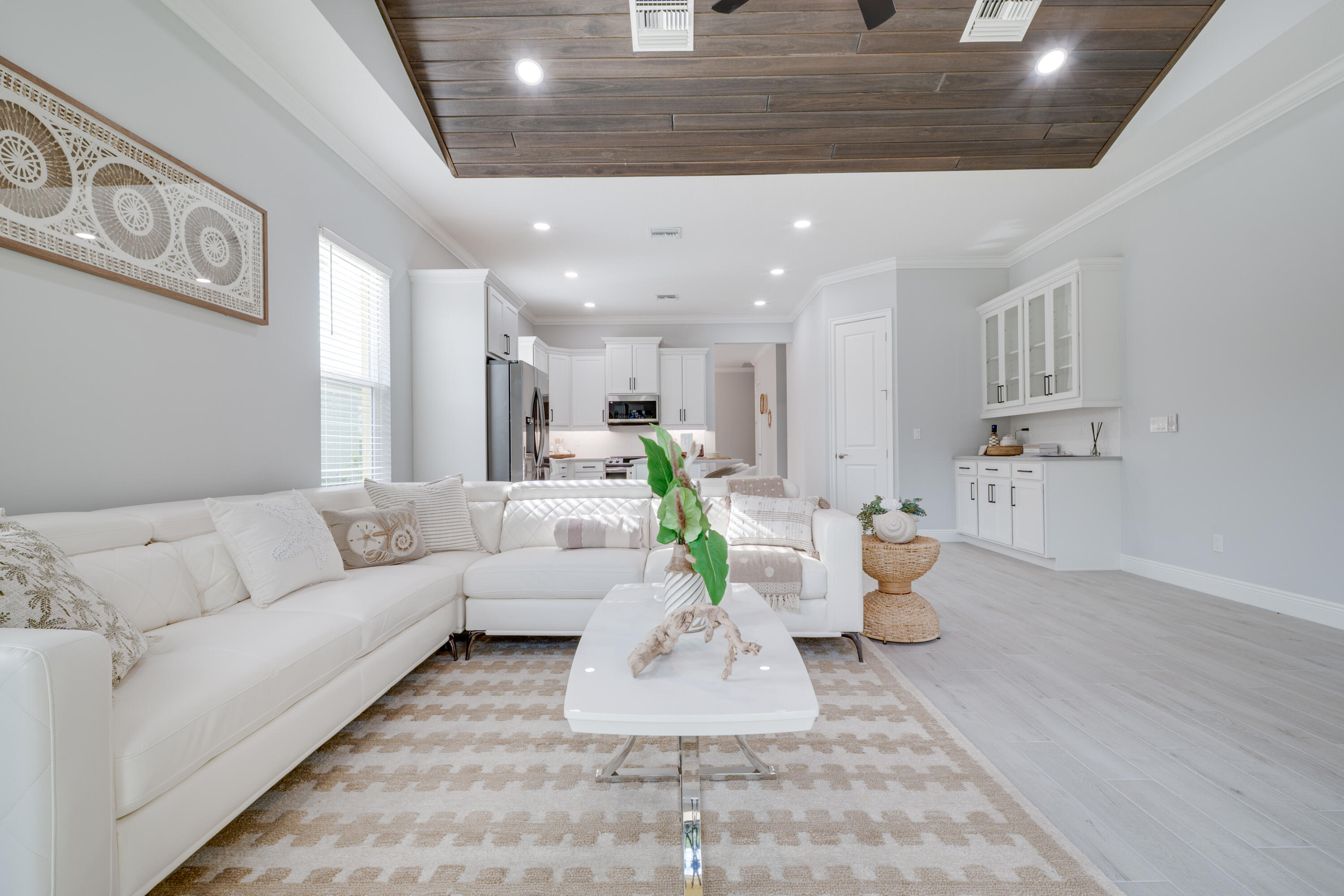 2005 Bridgepointe Circle, Unit 99 Vero Beach, FL 32967 - Photo 11 of 37 a living room with furniture and a dining table with kitchen view