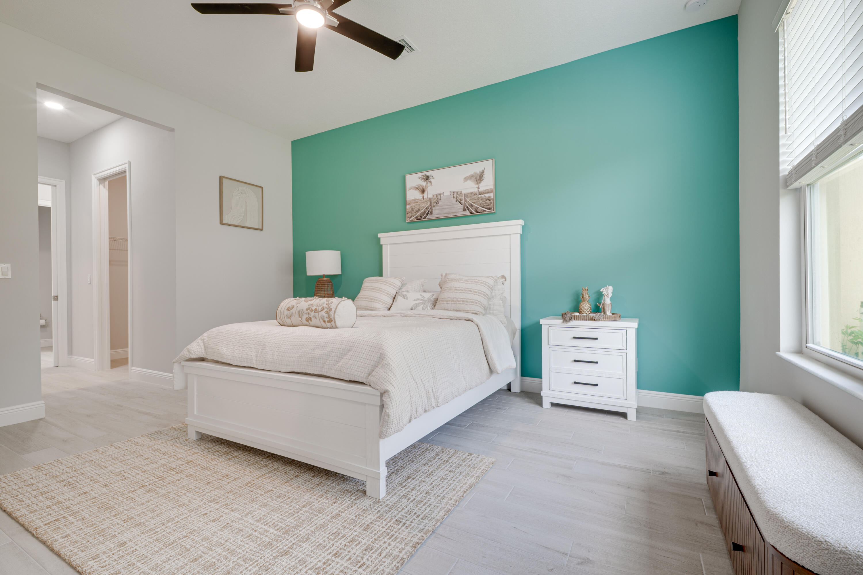 2005 Bridgepointe Circle, Unit 99 Vero Beach, FL 32967 - Photo 15 of 37 a bedroom with a bed and a chandelier