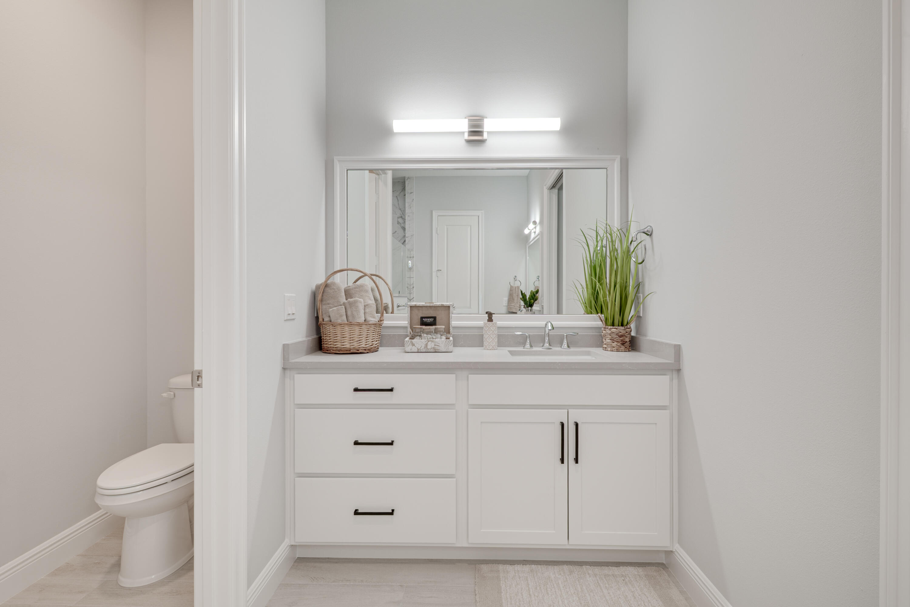 2005 Bridgepointe Circle, Unit 99 Vero Beach, FL 32967 - Photo 19 of 37 a bathroom with a granite countertop sink and a toilet