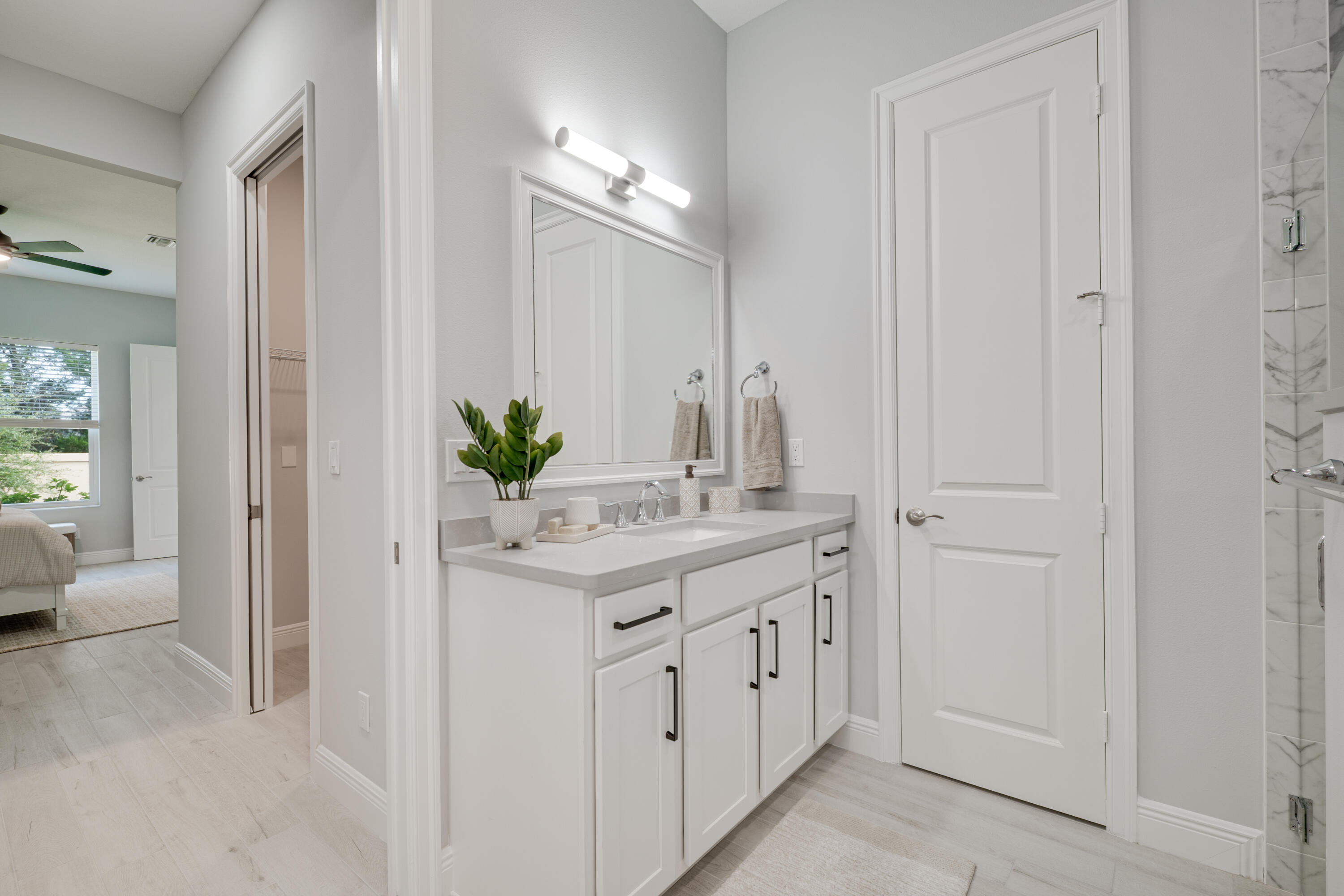 2005 Bridgepointe Circle, Unit 99 Vero Beach, FL 32967 - Photo 20 of 37 a bathroom with a granite countertop sink a mirror and a shower