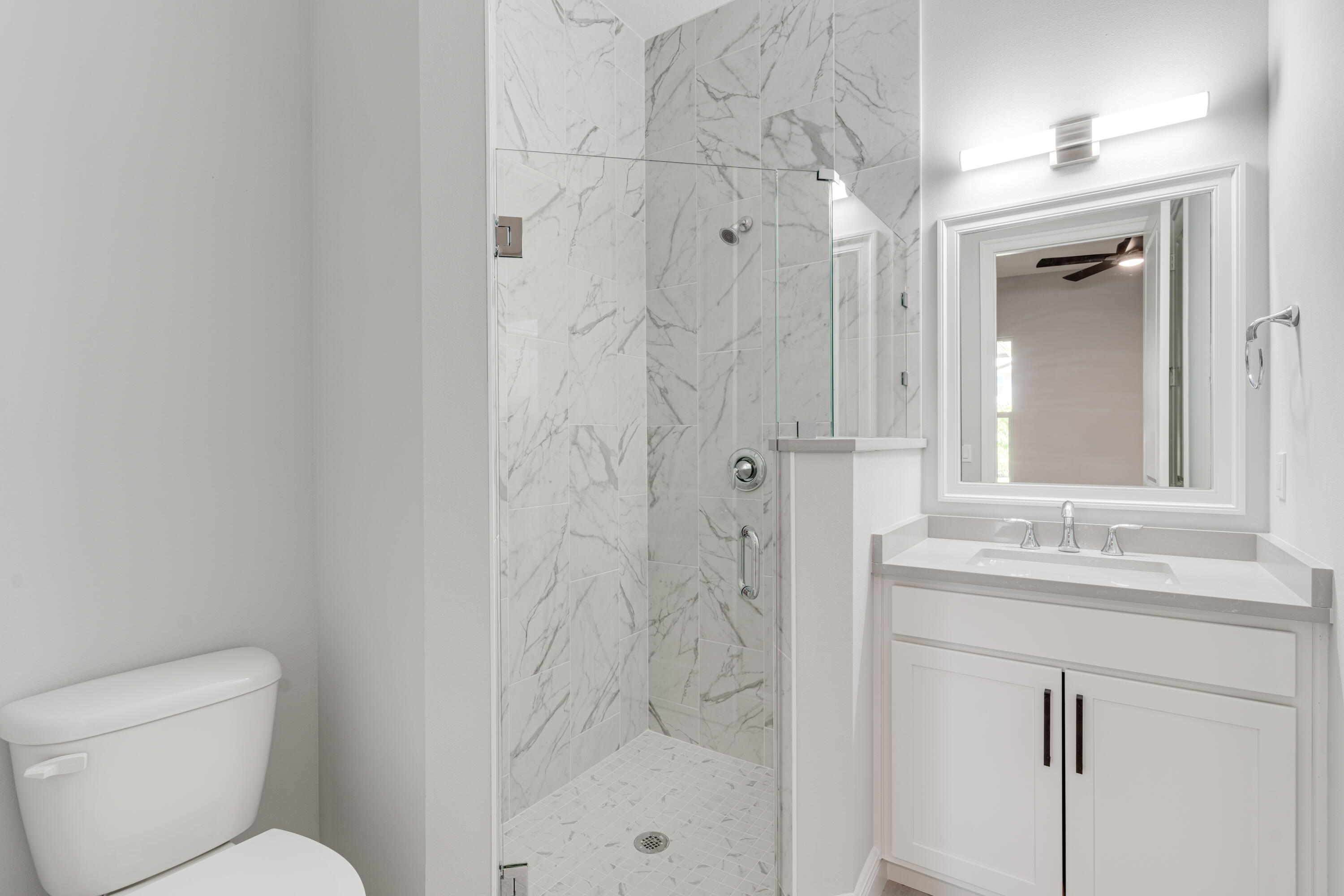 2005 Bridgepointe Circle, Unit 99 Vero Beach, FL 32967 - Photo 25 of 37 a bathroom with a granite countertop sink toilet and shower