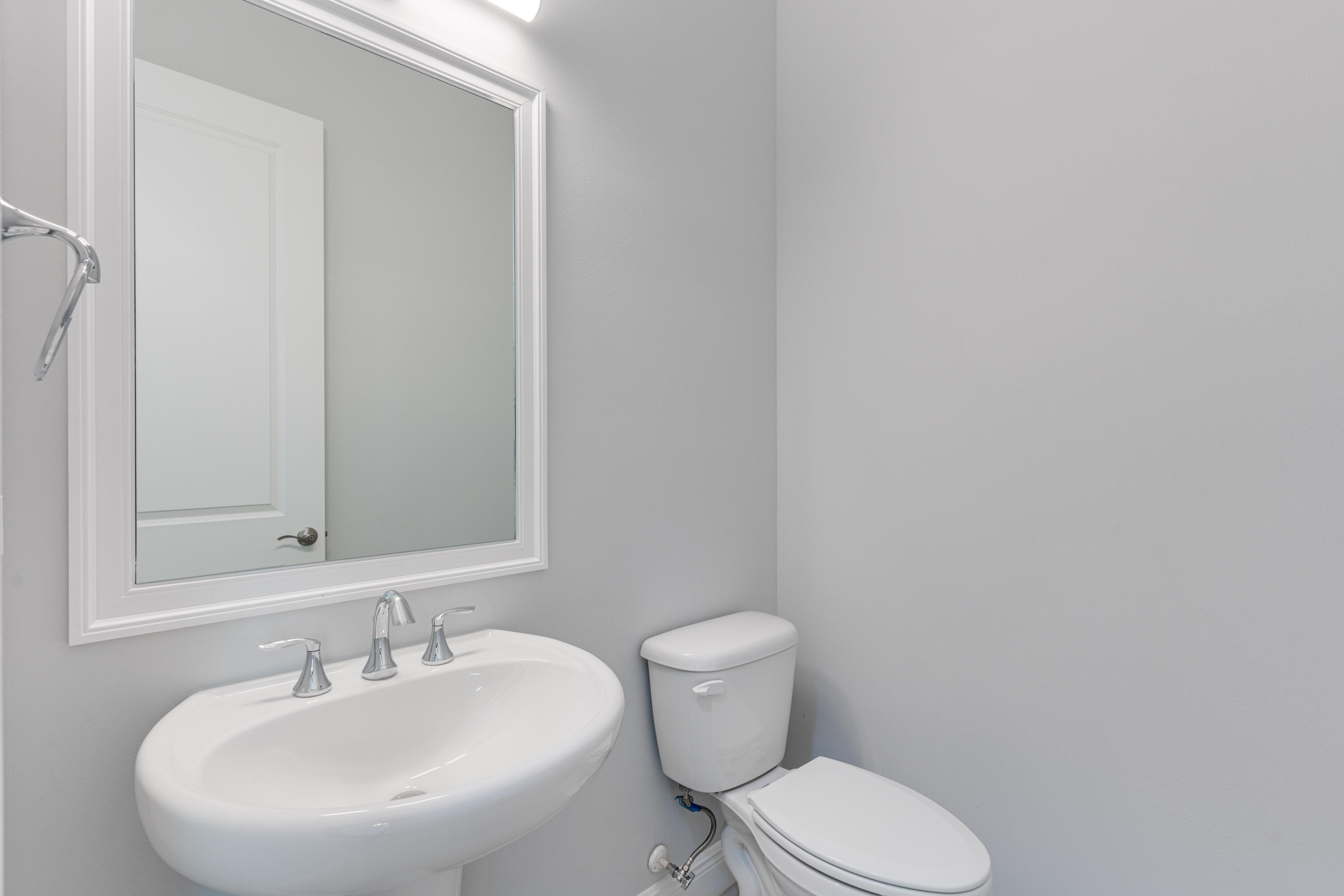 2005 Bridgepointe Circle, Unit 99 Vero Beach, FL 32967 - Photo 27 of 37 a bathroom with a toilet sink and mirror