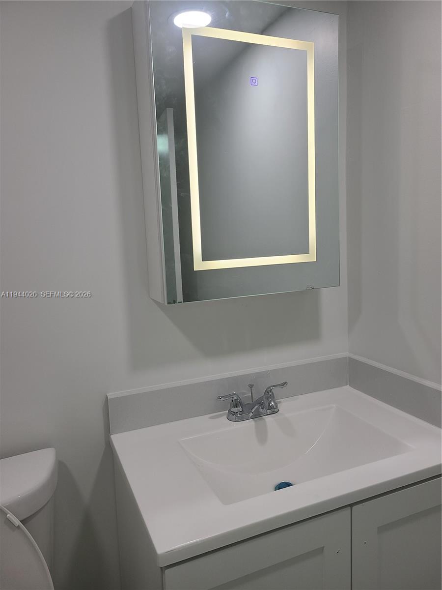 4713 Northwest 7th Street, Unit 1041 Miami, FL 33126 - Photo 11 of 19 a bathroom with a sink and a toilet