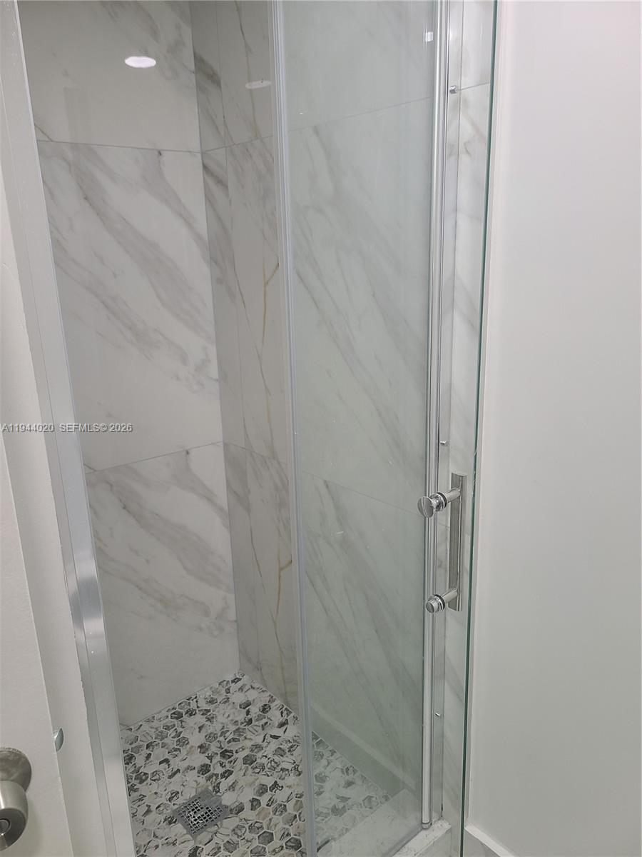 4713 Northwest 7th Street, Unit 1041 Miami, FL 33126 - Photo 12 of 19 a bathroom with a shower