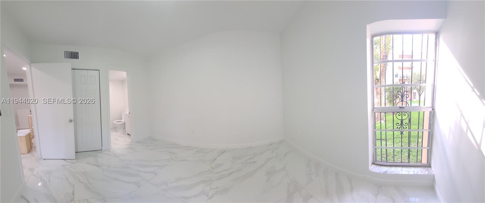 4713 Northwest 7th Street, Unit 1041 Miami, FL 33126 - Photo 15 of 19 an empty room with windows