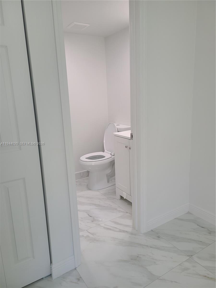 4713 Northwest 7th Street, Unit 1041 Miami, FL 33126 - Photo 17 of 19 a bathroom with a sink and a toilet