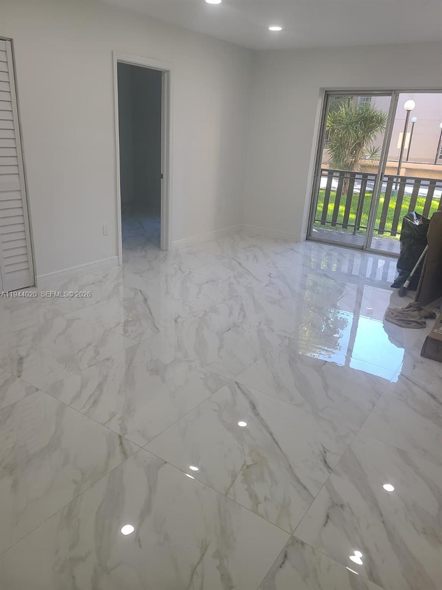 4713 Northwest 7th Street, Unit 1041 Miami, FL 33126 - Photo 2 of 19 en empty room with windows