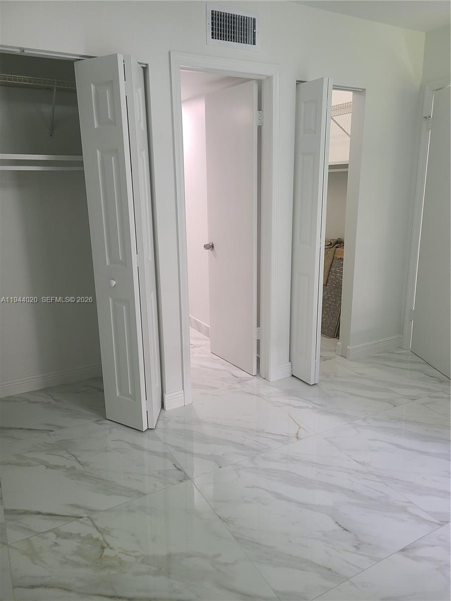 4713 Northwest 7th Street, Unit 1041 Miami, FL 33126 - Photo 7 of 19 an empty room with closet