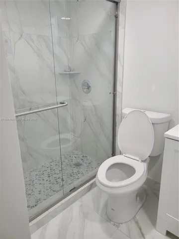 a bathroom with a sink toilet and mirror