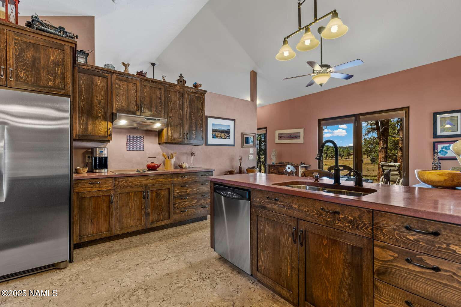 995 North Transwestern Pump Road Bellemont, AZ 86015 - Photo 31 of 81 a kitchen with cabinets a sink stainless steel appliances and a counter top space