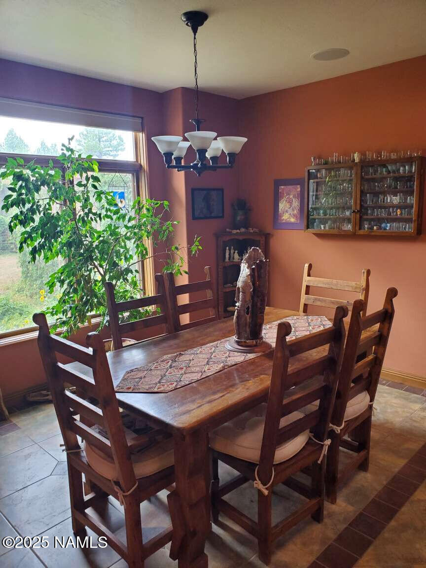 995 North Transwestern Pump Road Bellemont, AZ 86015 - Photo 39 of 81 a view of a dining room with furniture window and wooden floor