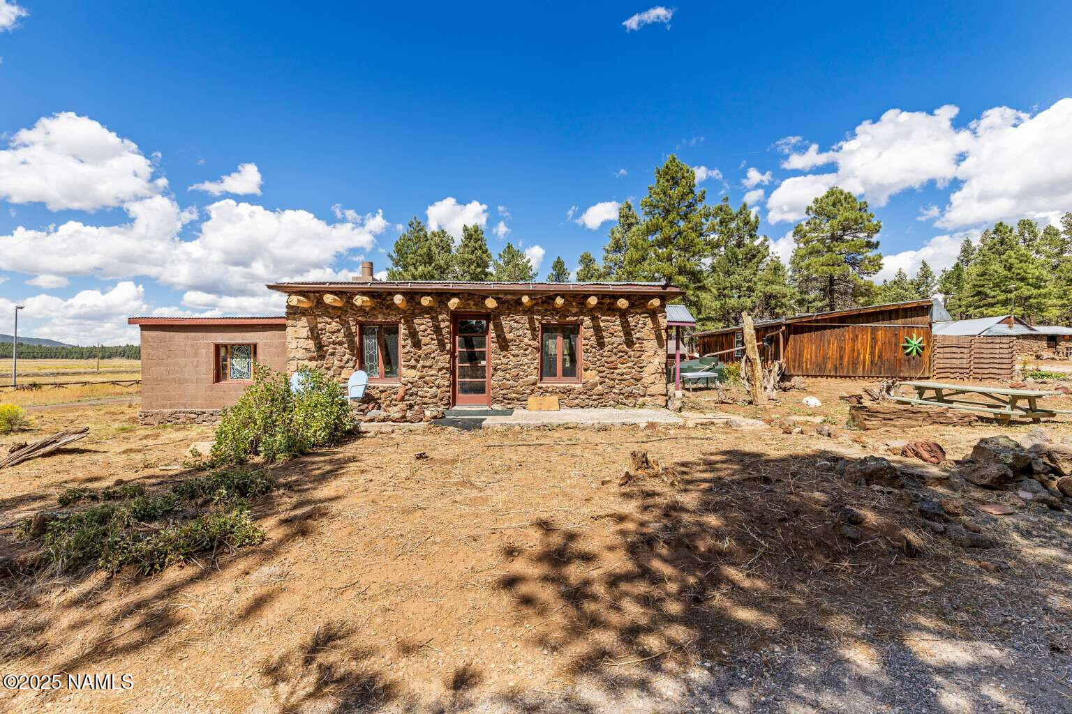 995 North Transwestern Pump Road Bellemont, AZ 86015 - Photo 61 of 81 a view of a house with floor to ceiling windows