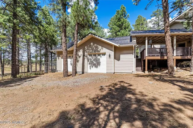 a spacious bathroom with a double vanity sink a mirror and a shower