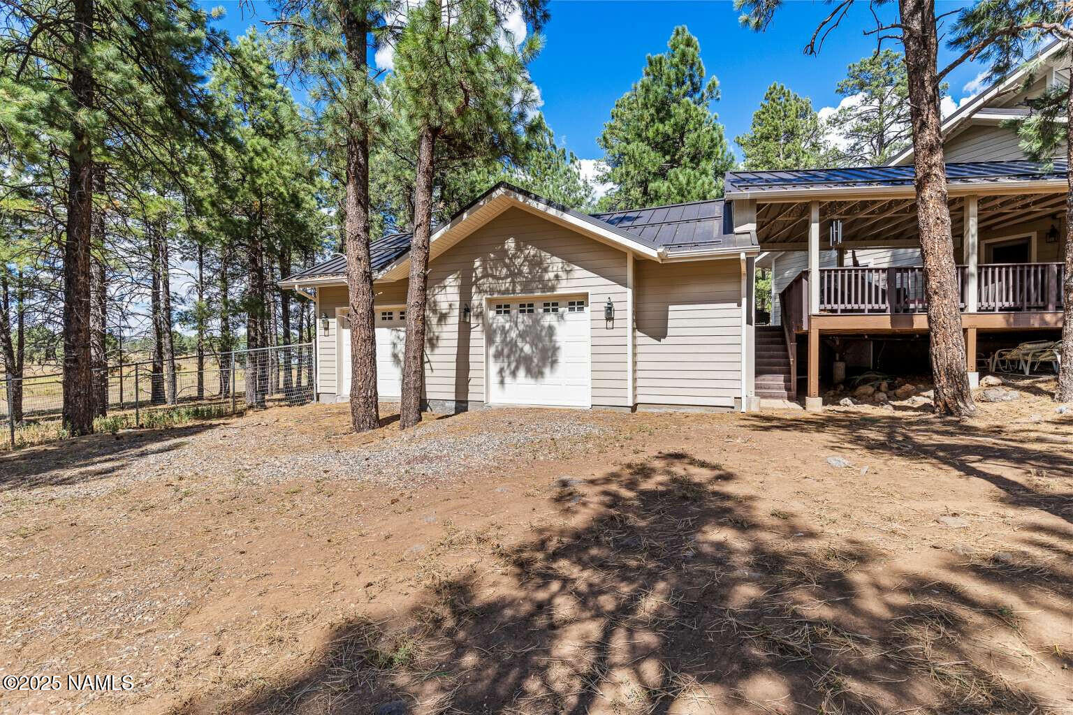 995 North Transwestern Pump Road Bellemont, AZ 86015 - Photo 9 of 81 a front view of a house with a yard and garage