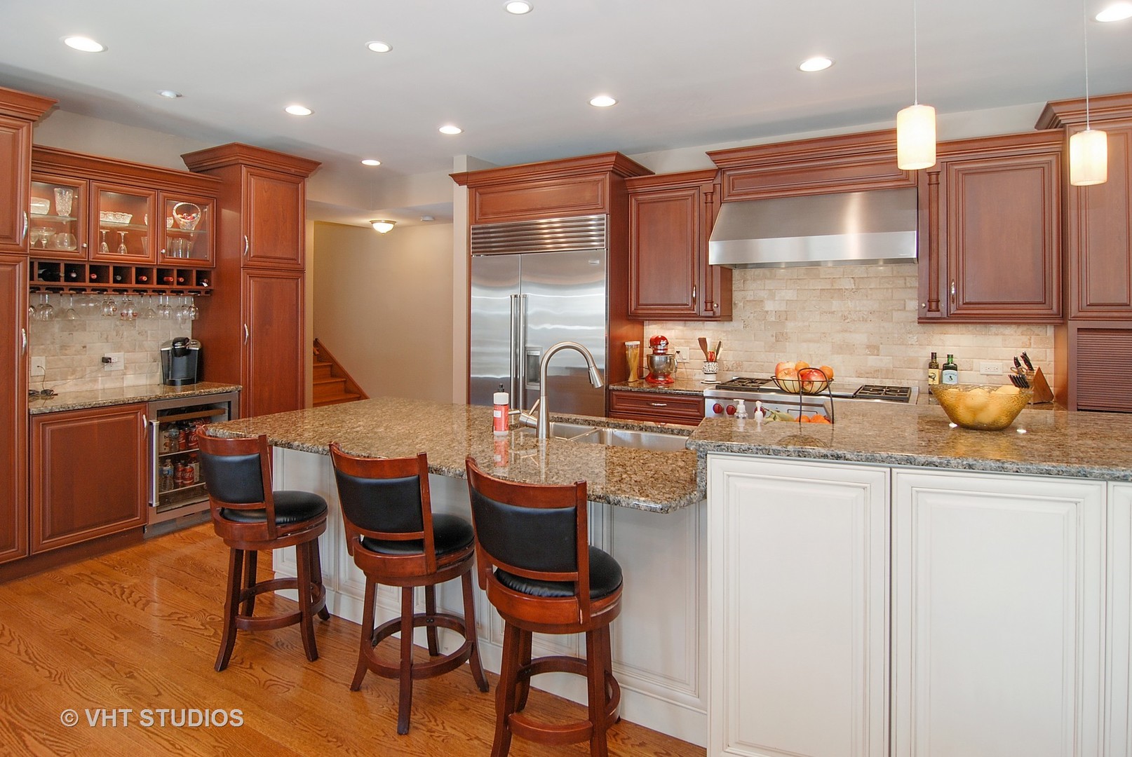 174 Fairbank Road Riverside, IL 60546 - Photo 5 of 31 a kitchen with kitchen island granite countertop wooden cabinets and a view of living room
