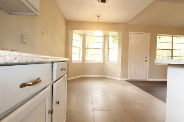 a view of a kitchen cabinets and a window