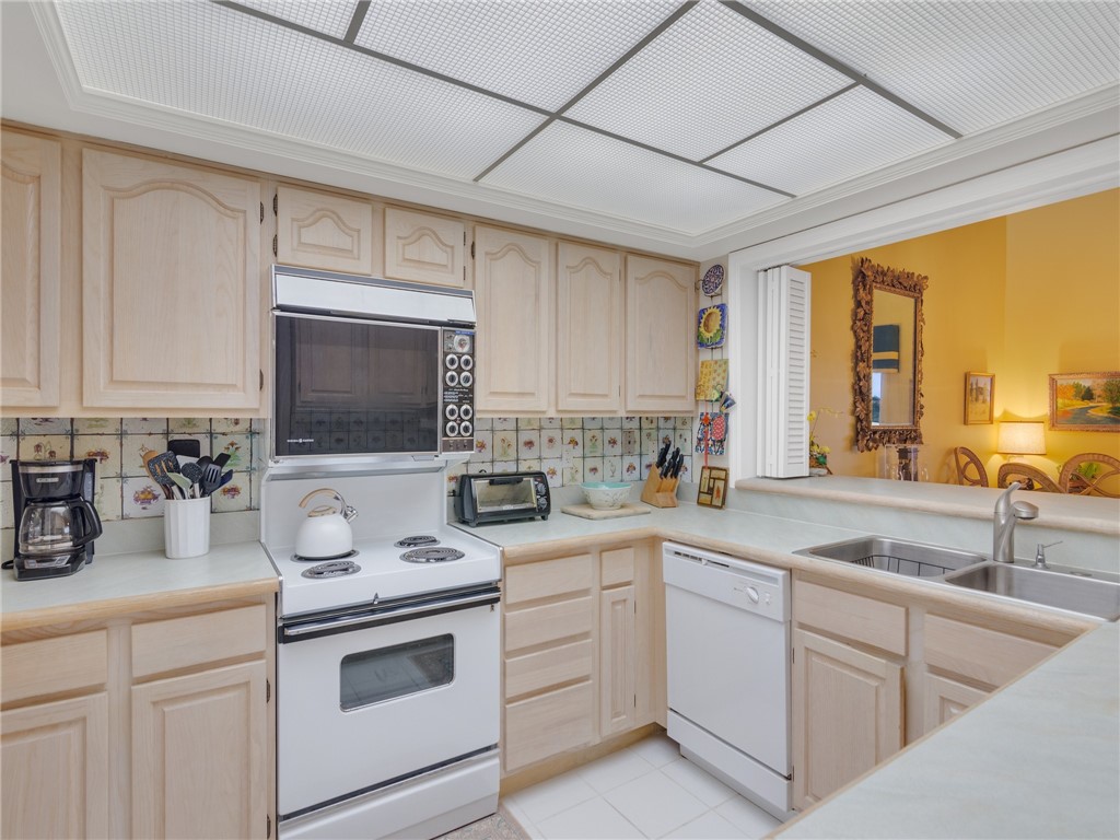 1880 Bay Road, Unit I319 Vero Beach, FL 32963 - Photo 11 of 36 a kitchen with a sink stove and microwave