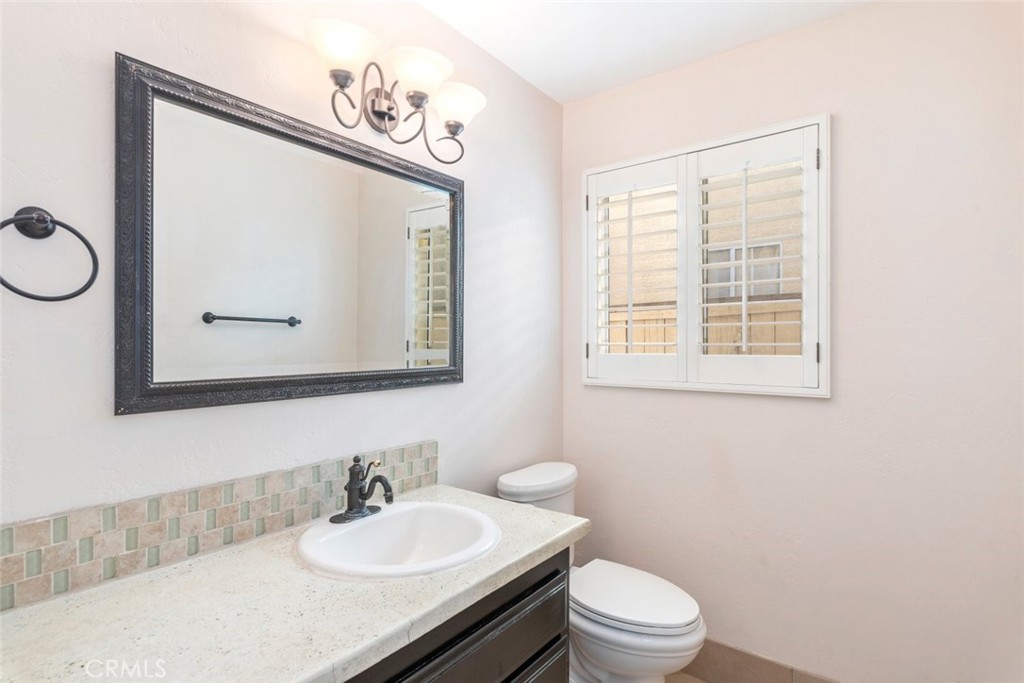 24075 Falconer Drive Murrieta, CA 92562 - Photo 10 of 25 a bathroom with a sink vanity mirror and toilet