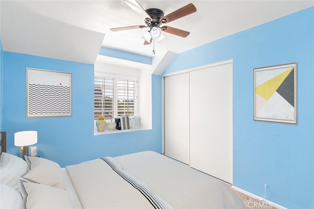 24075 Falconer Drive Murrieta, CA 92562 - Photo 15 of 25 a bedroom with a bed and a chandelier