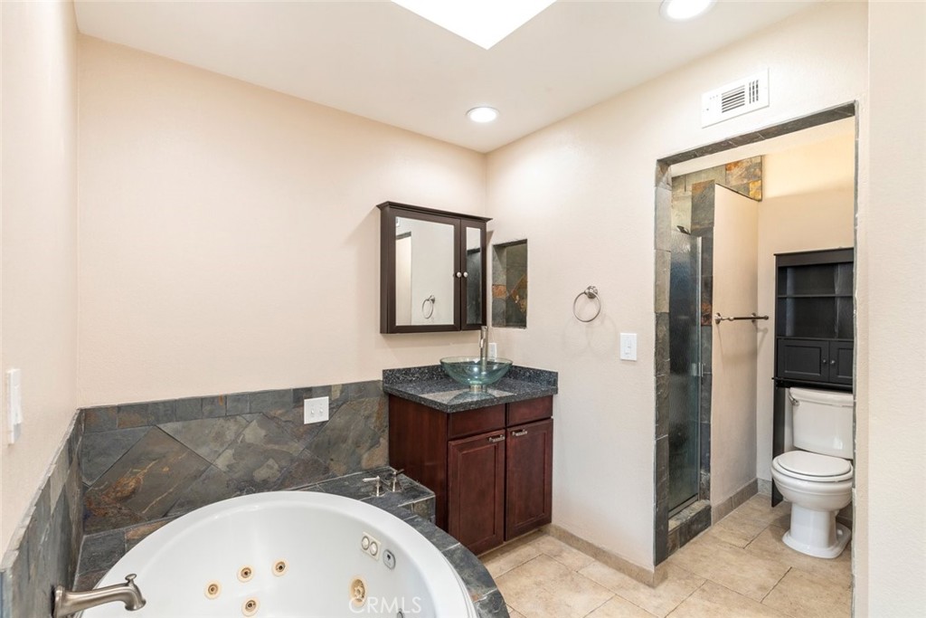 24075 Falconer Drive Murrieta, CA 92562 - Photo 17 of 25 a bathroom with a sink toilet and shower