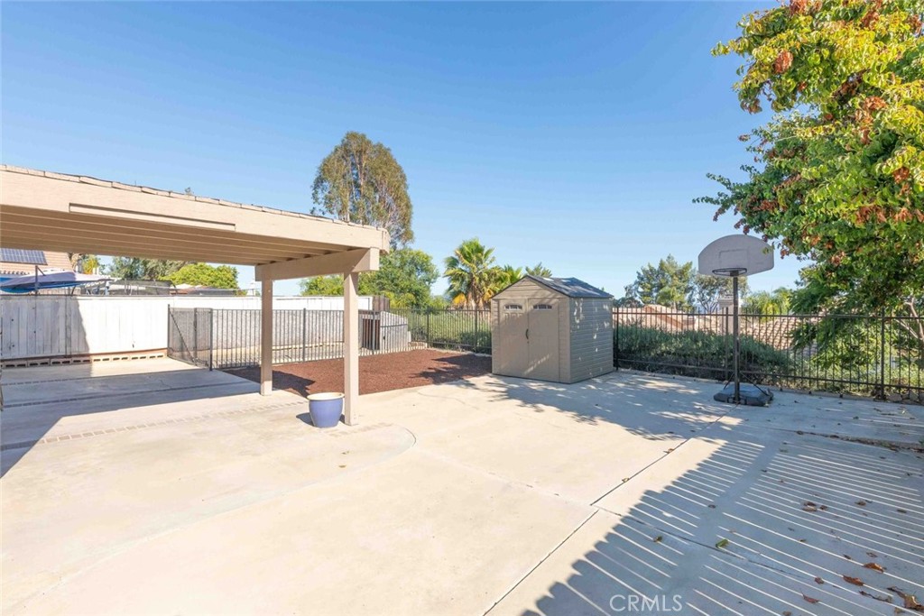 24075 Falconer Drive Murrieta, CA 92562 - Photo 20 of 25 a view of a patio with a table and chairs under an umbrella with wooden floor