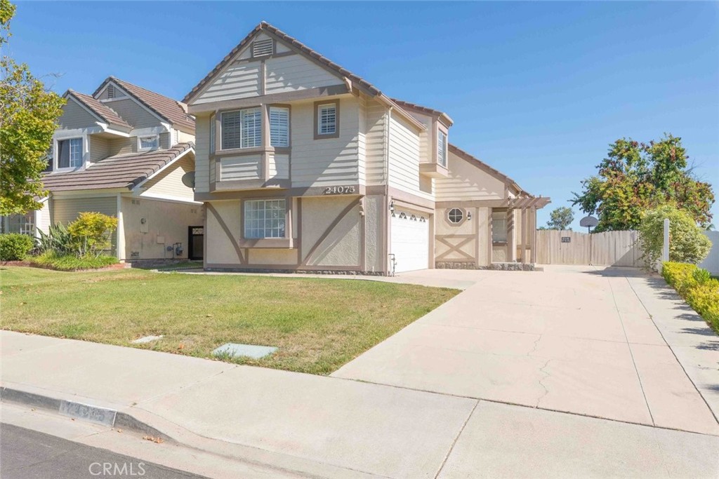 24075 Falconer Drive Murrieta, CA 92562 - Photo 4 of 25 a front view of a house with a yard