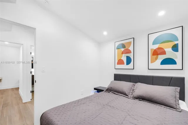 a bedroom with furniture and a flat screen tv