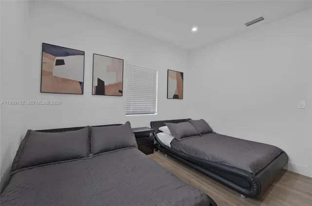 a bathroom with a sink vanity mirror and toilet