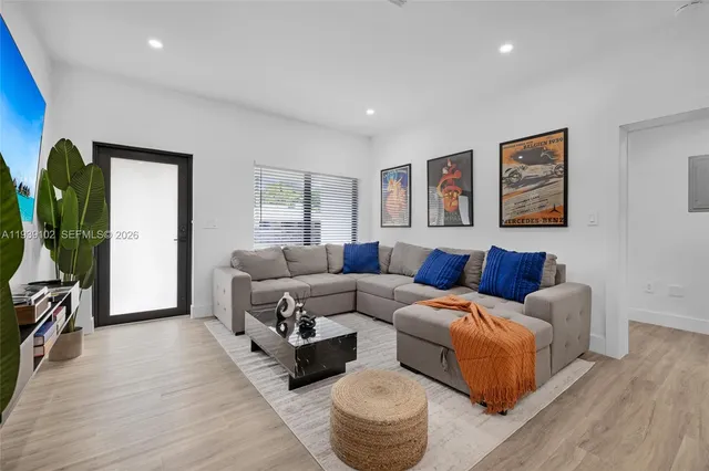 a living room with furniture kitchen view and a table